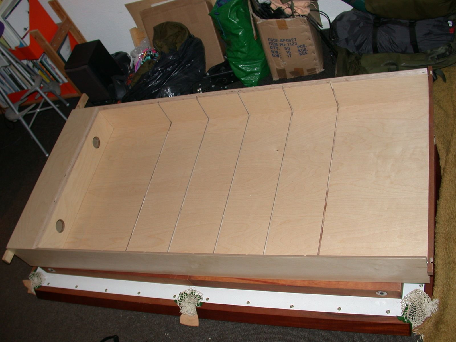 A large birch ply drawer box upside down in the garage