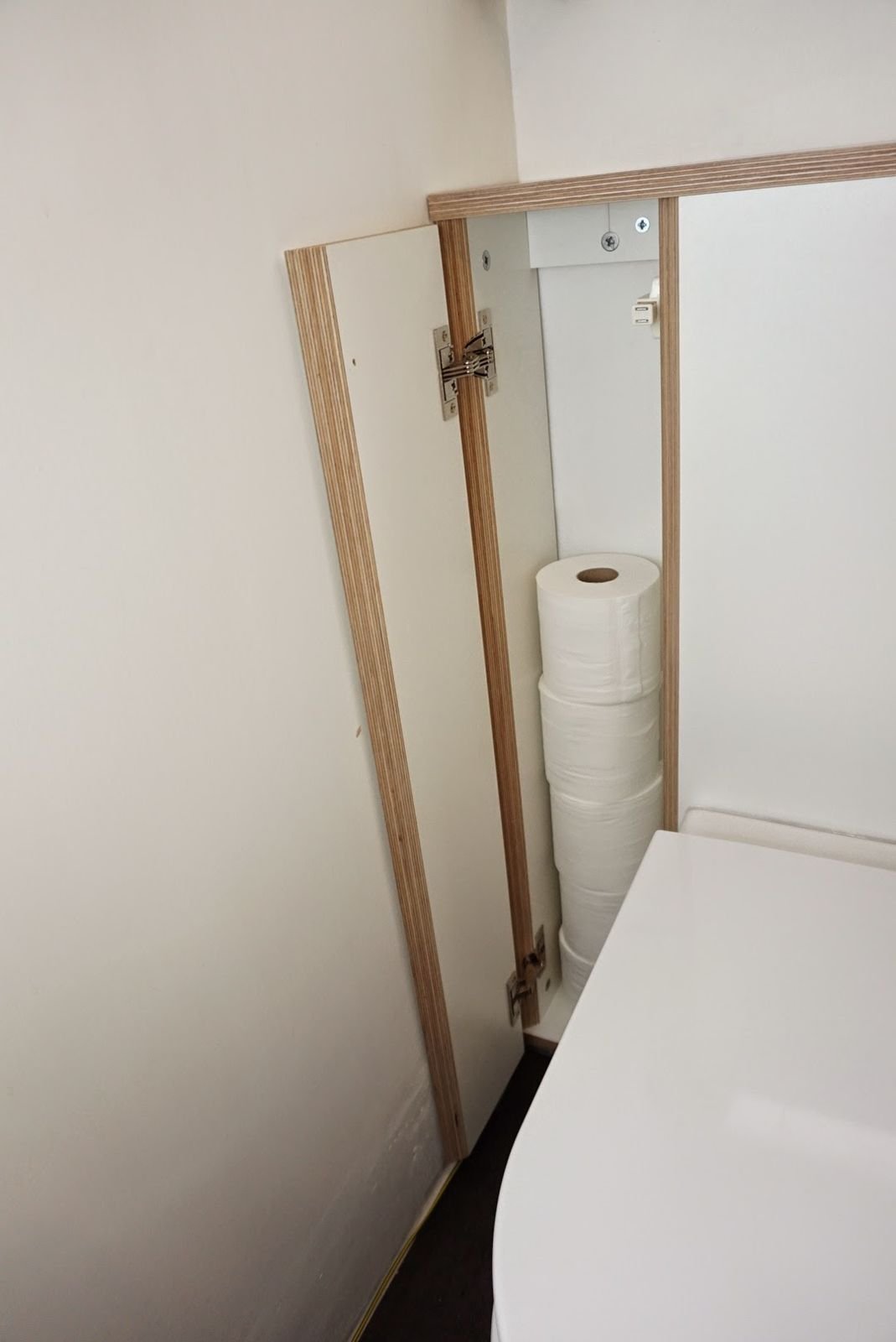 A full column of toilet rolls behind the side door