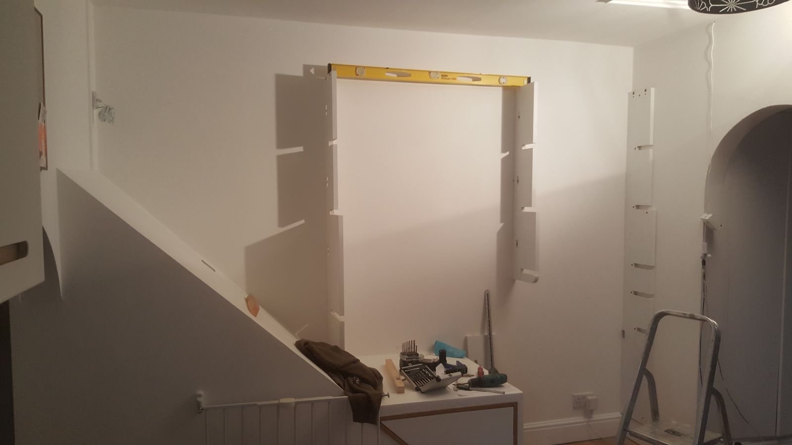 Vertical posts fixed to the wall with a spirit level on top