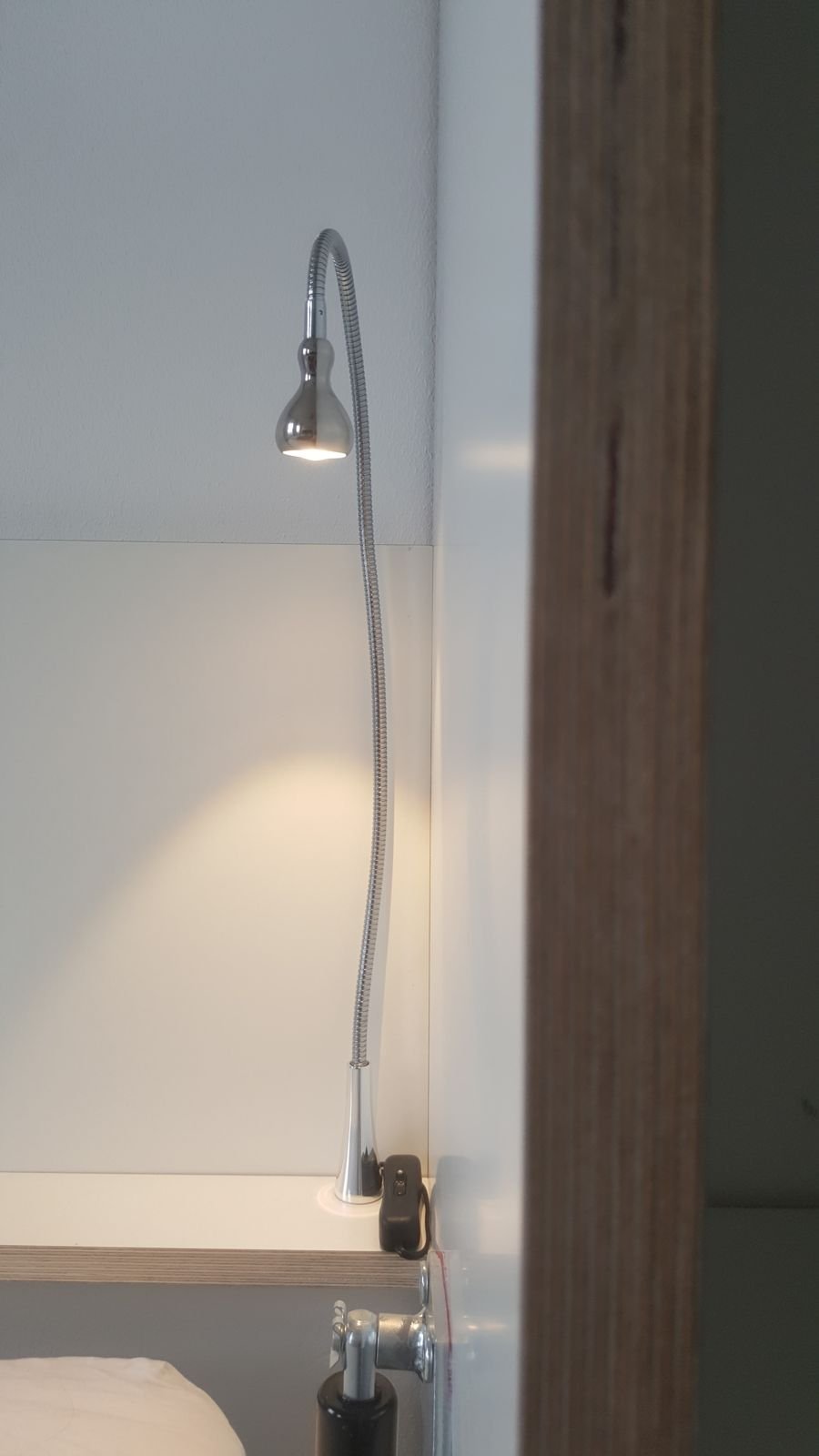 Swan neck reading light fixed inside the bed frame