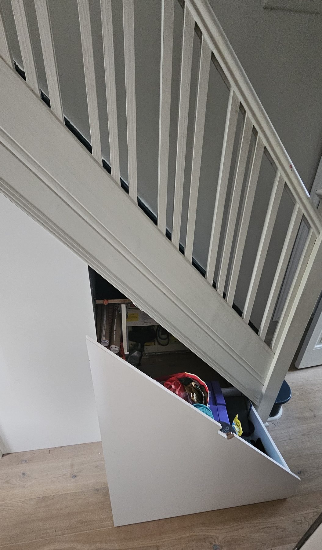 The angled drawer front part way out, with yoga mats and a helmet inside