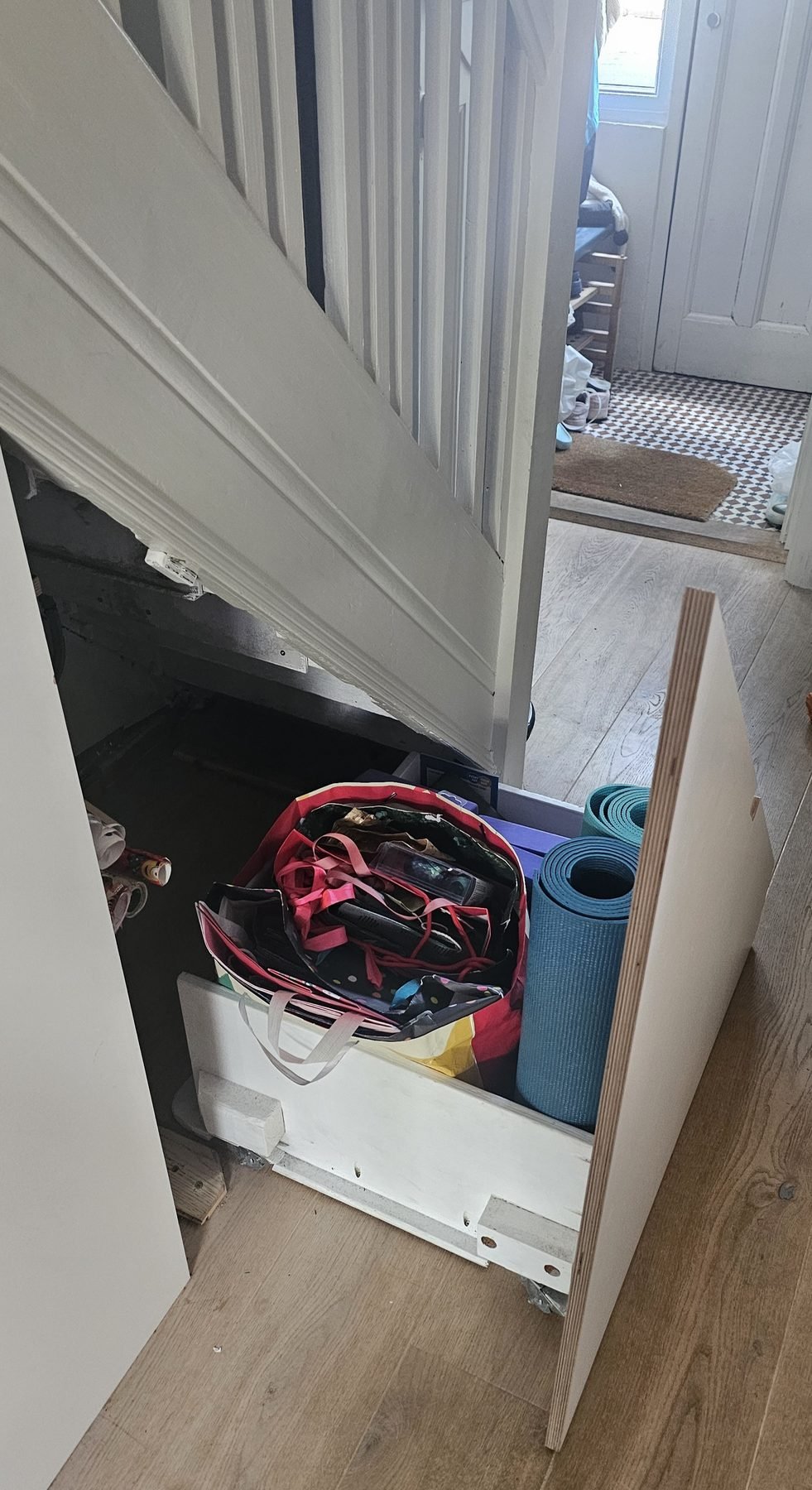The drawer pulled out into the hall, showing the space behind it