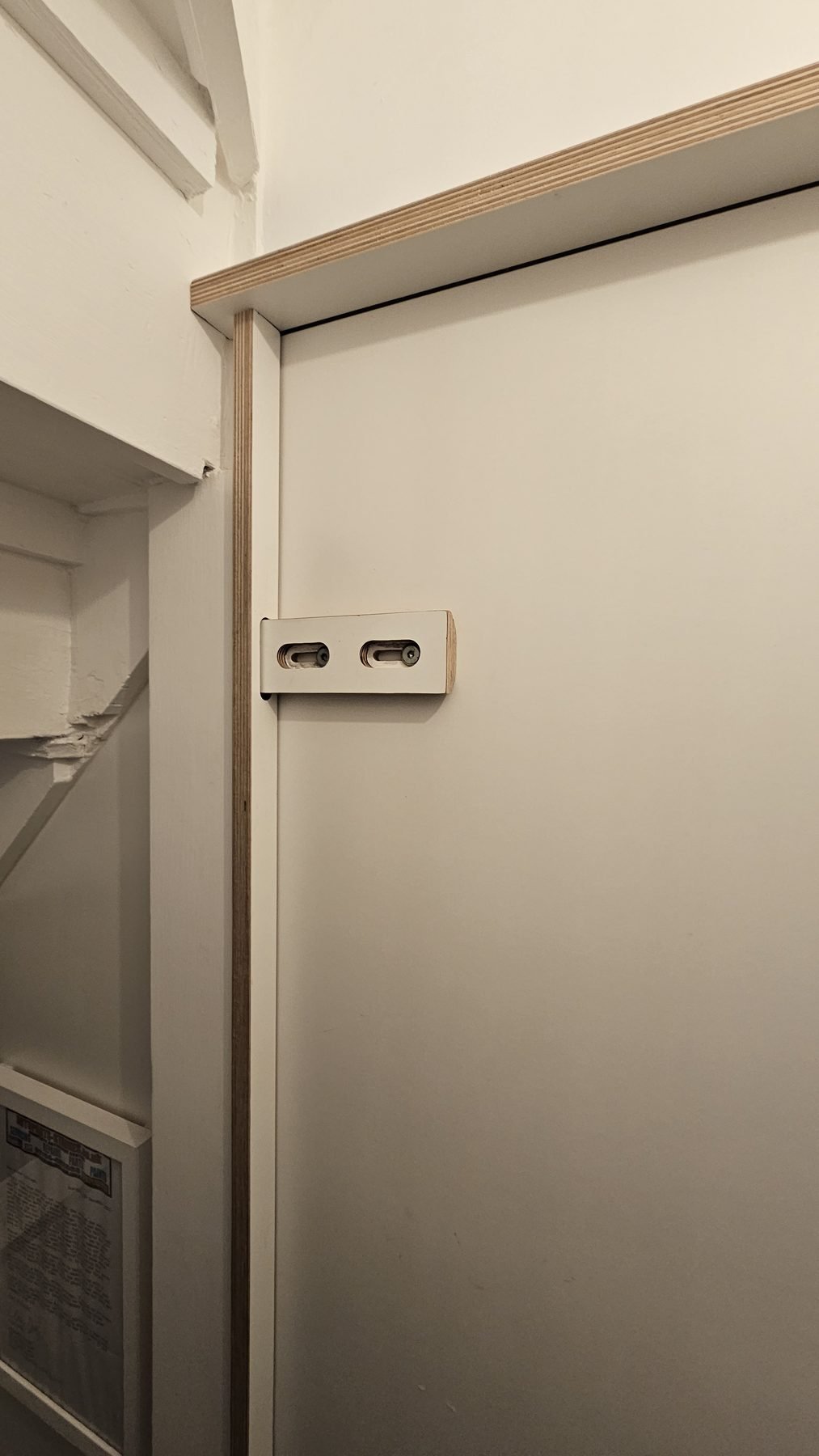 Plywood sliding lock on the inside of the toilet door, closed