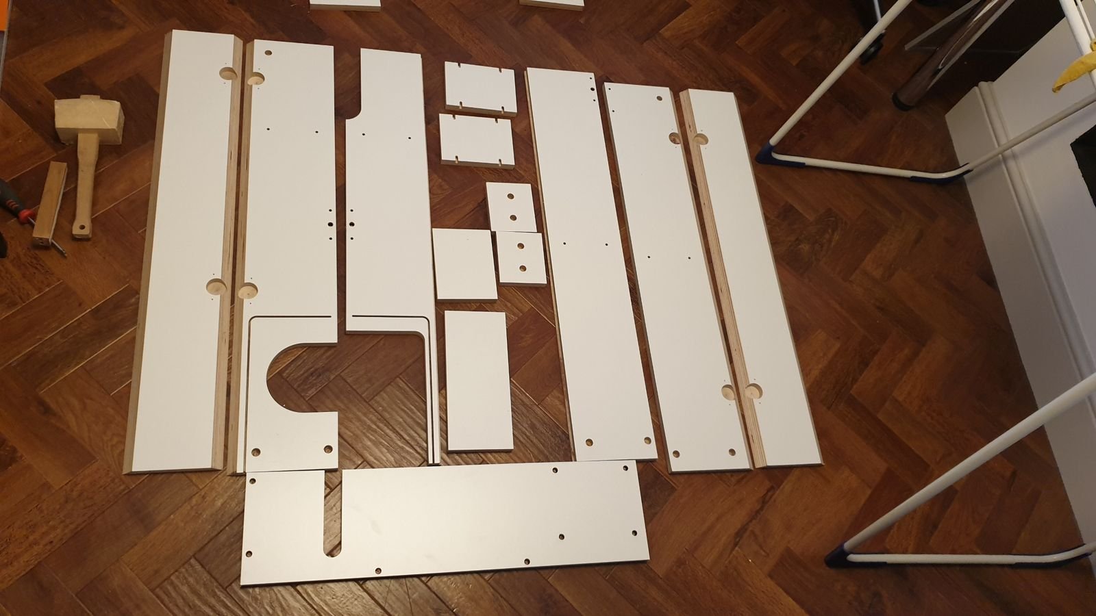 The cut birch ply parts laid out on the floor ready to assemble